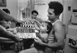 Robert De Niro with baby and clapperboard on the set of Raging Bull (1980)